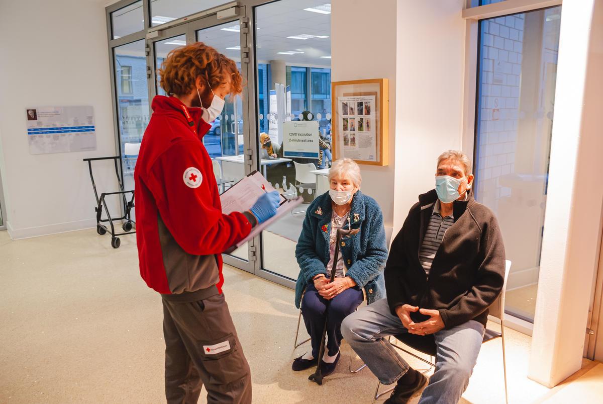 British Red Cross Volunteer Fabian Talking To A Couple After They   150.50 